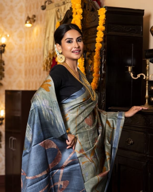 Nakshipar Occur Yellow, Brown and Blue Floral on self Printed Gray Tussar Saree